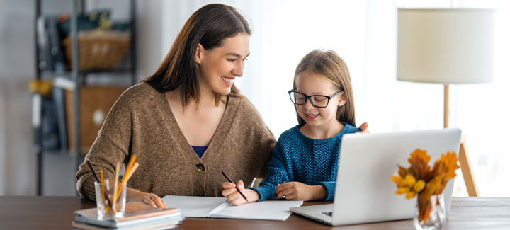 Smiling parent and child learning at home office